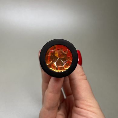 Силиконовая анальная пробка - черная с оранжевым кристаллом (2,8 см) - фото