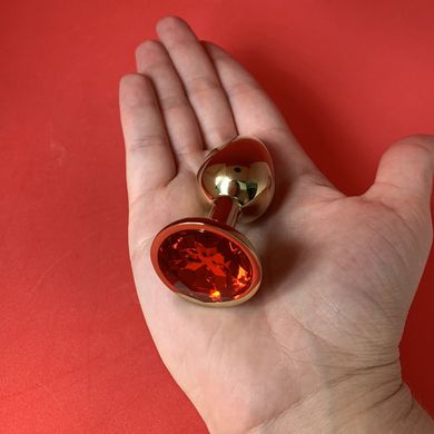 Золота анальна пробка з червоним кристалом (2,8 см) - фото
