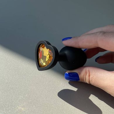 Силиконовая анальная пробка сердечко - черная с оранжевым кристаллом (2,8 см) - фото