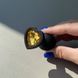 Силіконова анальна пробка сердечко - чорна з помаранчевим кристалом (2,8 см) - фото товару
